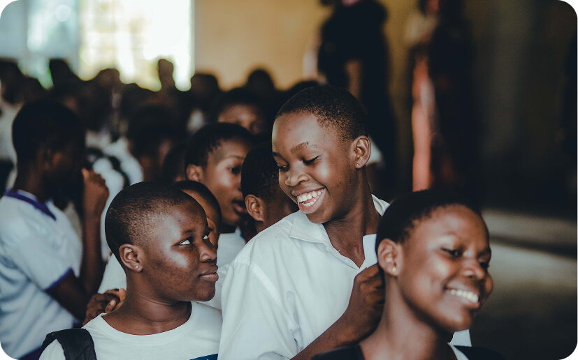 FGC Kano pupils smiling and raising their hands during a lesson