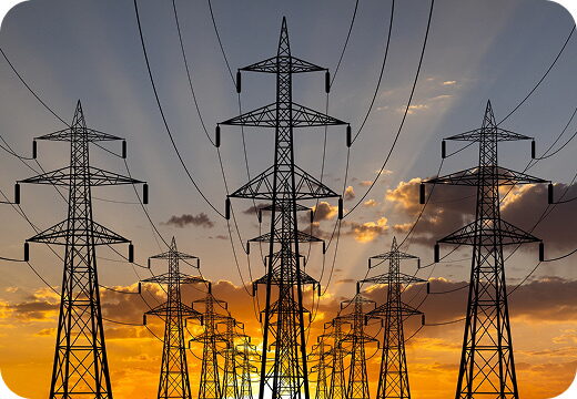 High-voltage transmission pylons at sunset