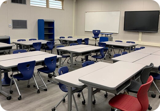 A teaching room with a large wall-mounted display screen